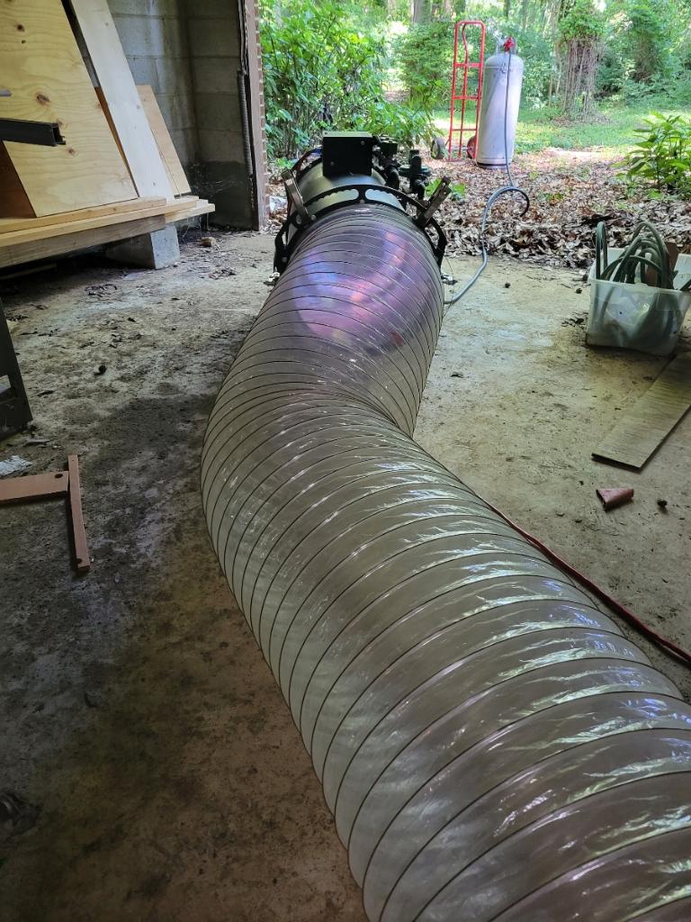 Heat treatment hose routed into a home entry during an Enviro Heat service visit